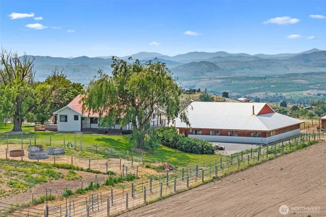 a view of a house with a yard and mountain view