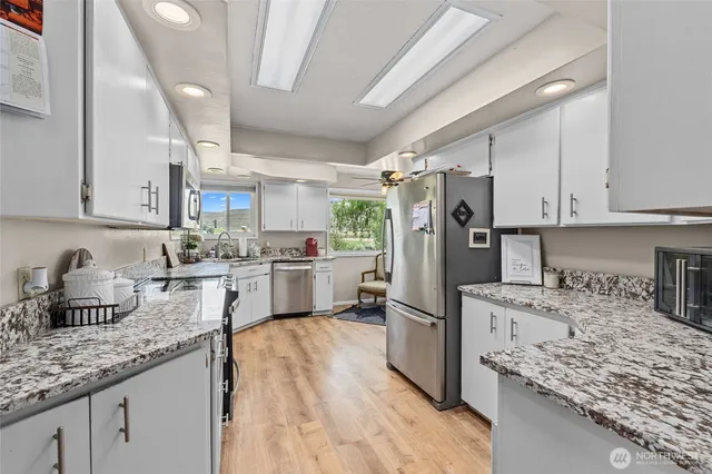 a kitchen with refrigerator and cabinets