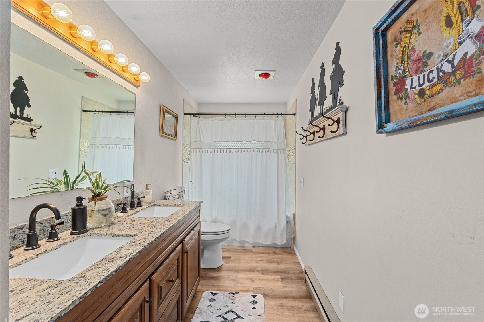 93 Warren Road Tonasket, WA 98855 - Photo 10 of 31 a bathroom with a granite countertop sink and a mirror