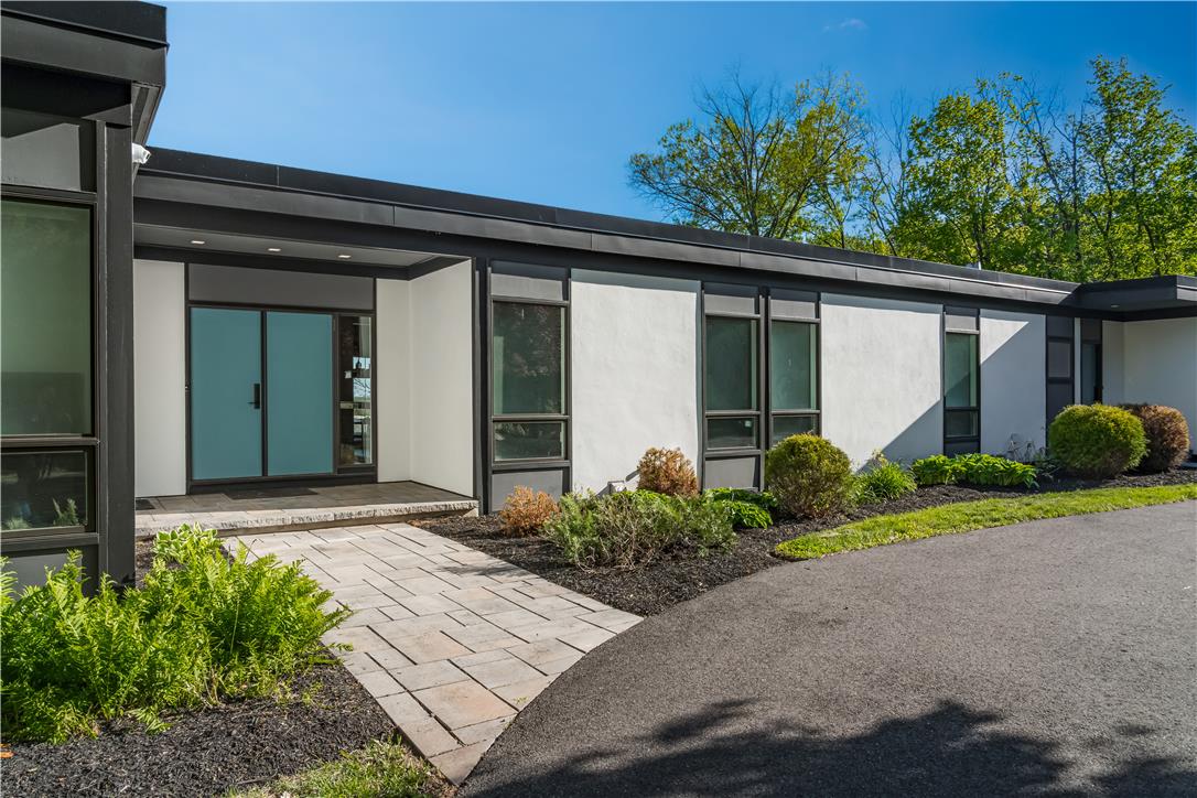 1506 Pleasant View Road Coopersburg, PA 18036 - Photo 3 of 97 A striking modern facade with clean lines welcomes guests via a paved walkway.
