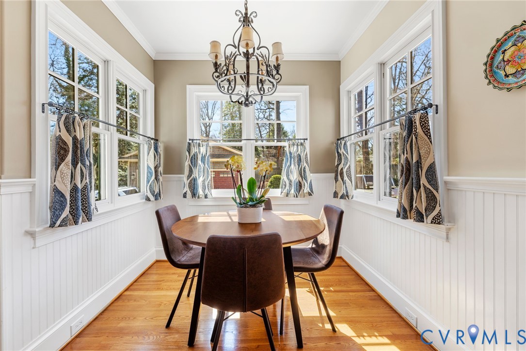8947 Cherokee Road Richmond, VA 23235 - Photo 16 of 45 a view of a dining room with furniture and a chandelier