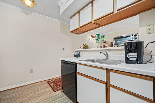 a kitchen with a sink cabinets and appliances