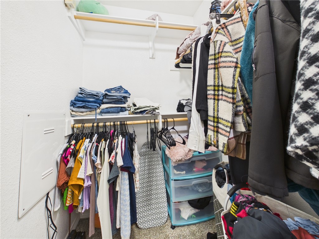 1000 Spring Loop, Unit 2103 College Station, TX 77840 - Photo 17 of 28 a view of walk in closet with clothes and shoes
