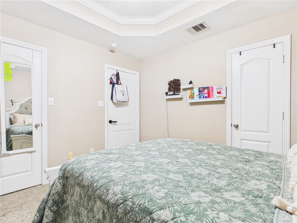 1000 Spring Loop, Unit 2103 College Station, TX 77840 - Photo 20 of 28 a bedroom with a bed and a window
