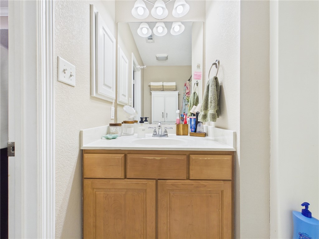 1000 Spring Loop, Unit 2103 College Station, TX 77840 - Photo 21 of 28 a bathroom with a sink and a mirror