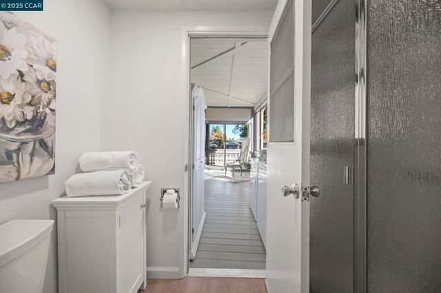 a hallway with a view of living room washer and dryer