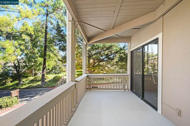 a view of a porch with wooden floor and outdoor space