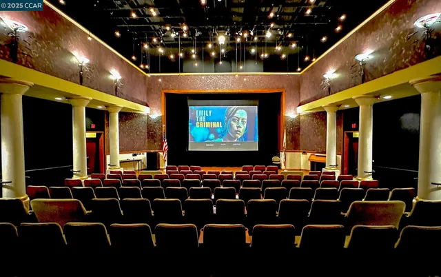 a room with furniture projector and screen