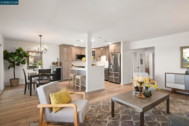 a living room with furniture and kitchen view