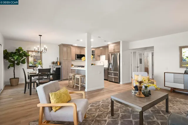 a living room with furniture and kitchen view