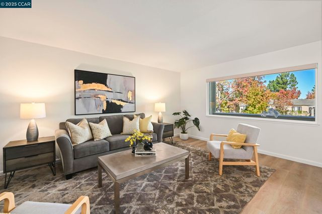 a living room with furniture and painting on the wall