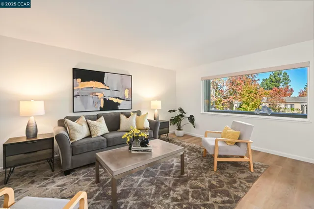 a living room with furniture and painting on the wall