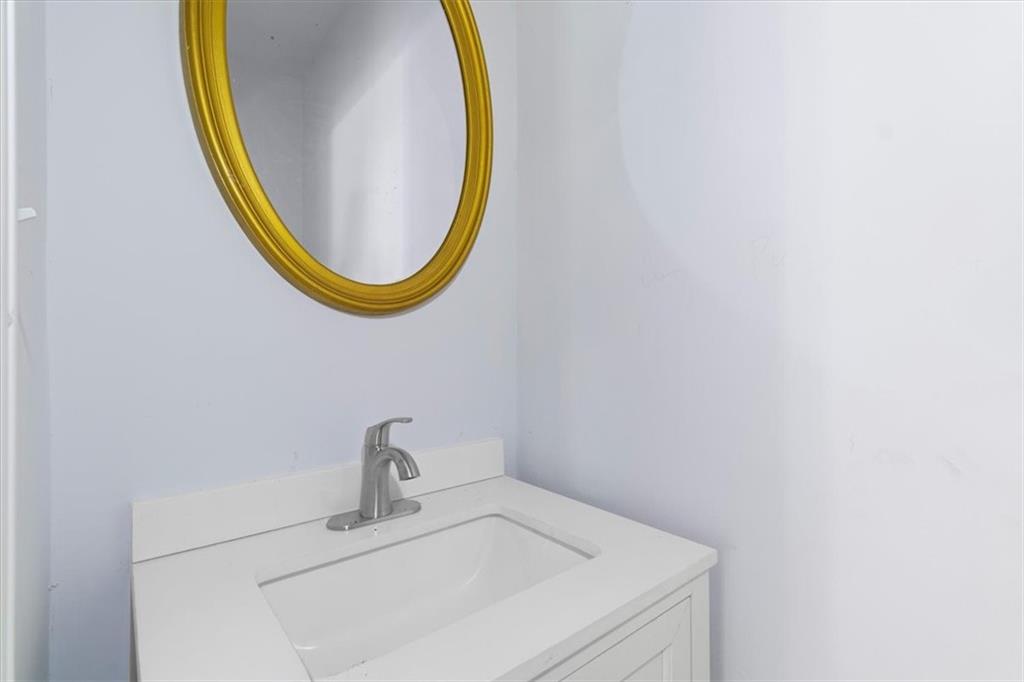 1347 Westmont Road Southwest Atlanta, GA 30311 - Photo 13 of 26 a bathroom with a sink and a mirror