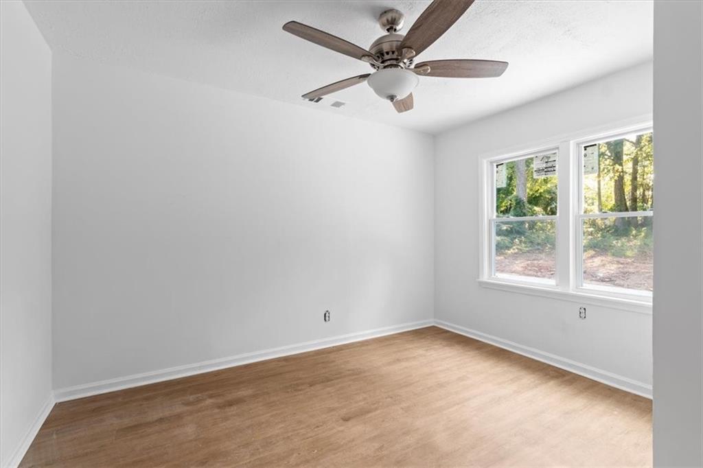 1347 Westmont Road Southwest Atlanta, GA 30311 - Photo 14 of 26 an empty room with a window and a fan
