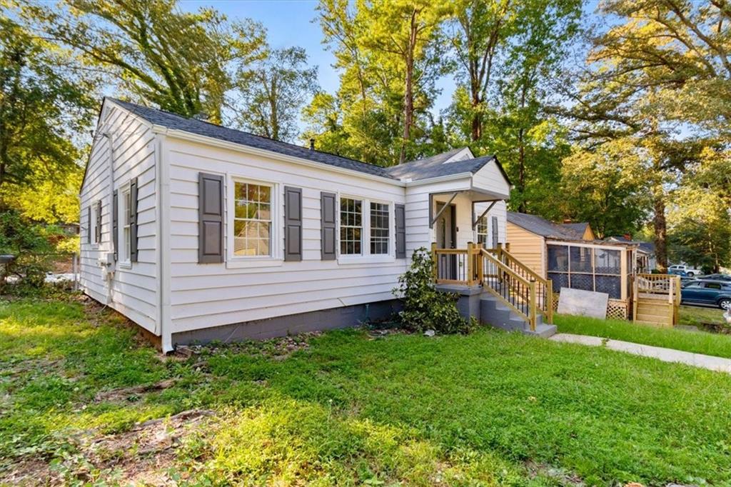 1347 Westmont Road Southwest Atlanta, GA 30311 - Photo 21 of 26 a view of a house with a yard and wooden fence