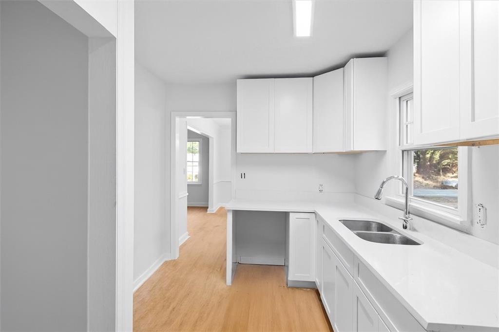 1347 Westmont Road Southwest Atlanta, GA 30311 - Photo 5 of 26 a kitchen with a sink a stove and cabinets