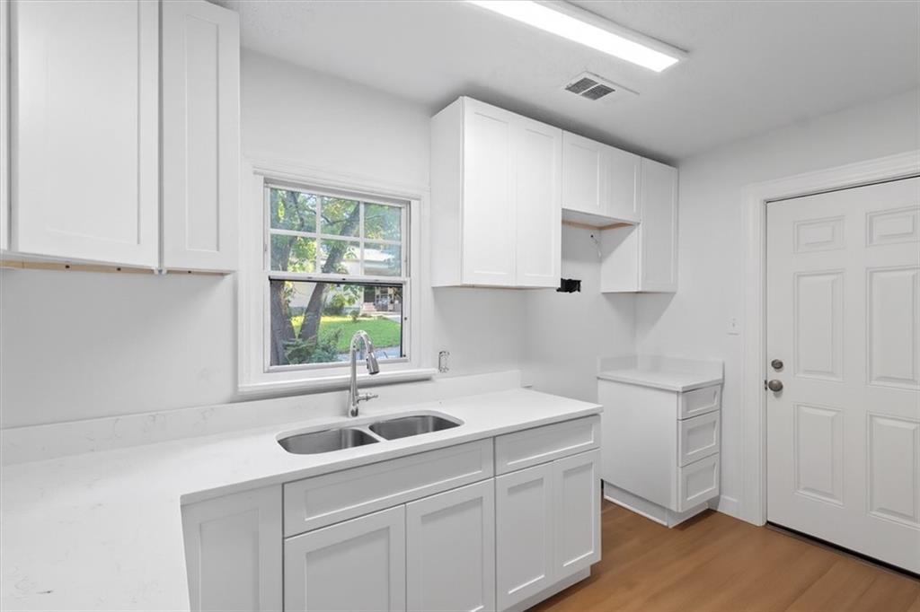 1347 Westmont Road Southwest Atlanta, GA 30311 - Photo 6 of 26 a kitchen with a sink cabinets and window