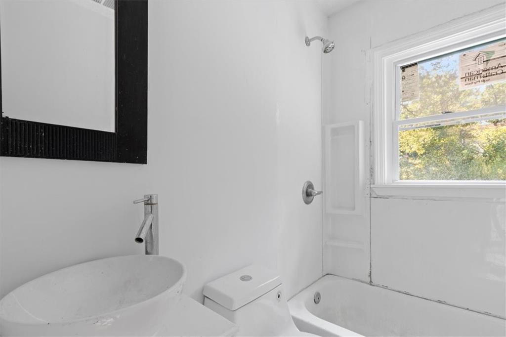 1347 Westmont Road Southwest Atlanta, GA 30311 - Photo 9 of 26 a bathroom with a tub sink and mirror