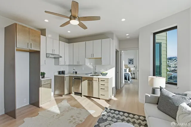 a bathroom with a tub a potted plant and a shower