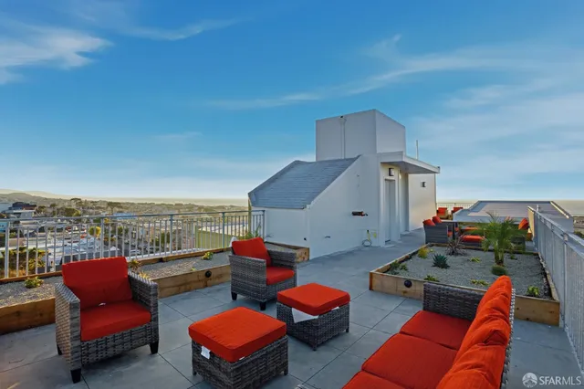 a outdoor living space with furniture and city view