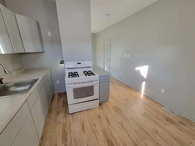 a kitchen with a stove a sink and a microwave