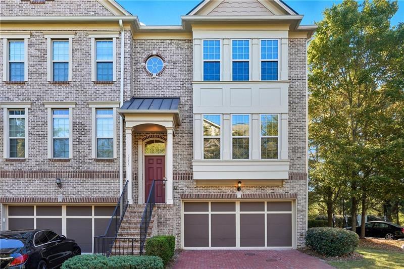 3655 East Paces Walk Atlanta, GA 30326 - Photo 1 of 31 a front view of a house with a yard