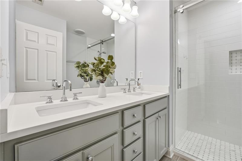 3655 East Paces Walk Atlanta, GA 30326 - Photo 11 of 31 a bathroom with a sink double vanity and a mirror