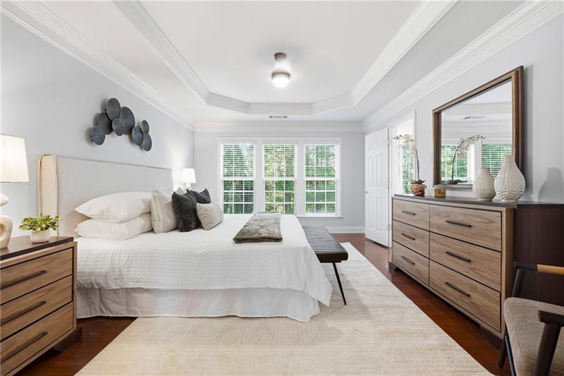 3655 East Paces Walk Atlanta, GA 30326 - Photo 12 of 31 a bedroom with a large bed and windows