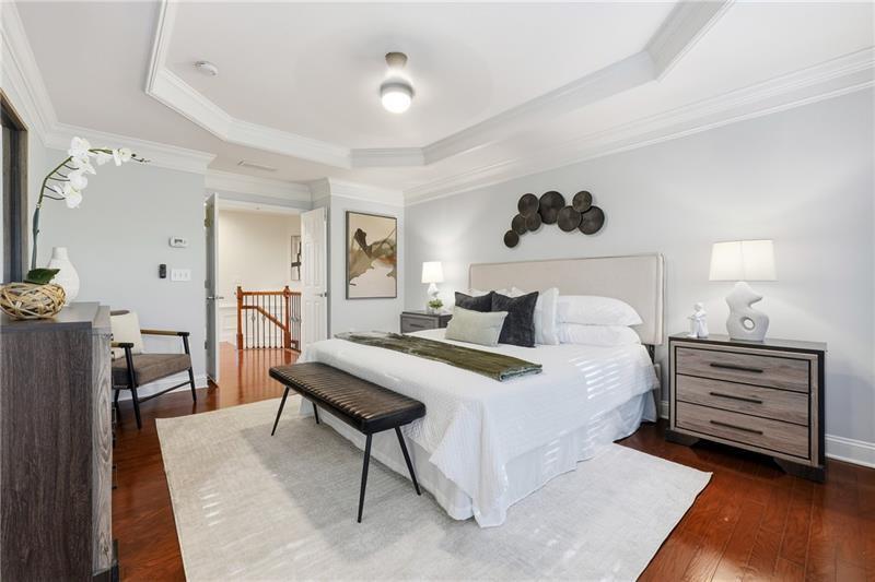 3655 East Paces Walk Atlanta, GA 30326 - Photo 13 of 31 a bedroom with a bed and wooden floor