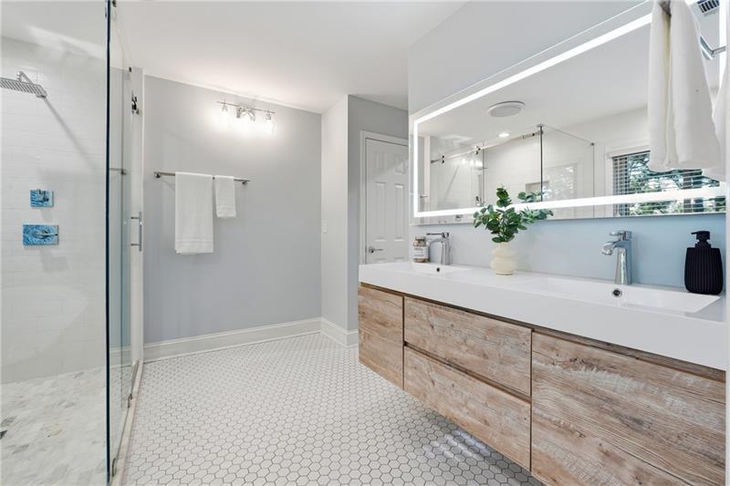 3655 East Paces Walk Atlanta, GA 30326 - Photo 14 of 31 a bathroom with a double vanity sink mirror and shower