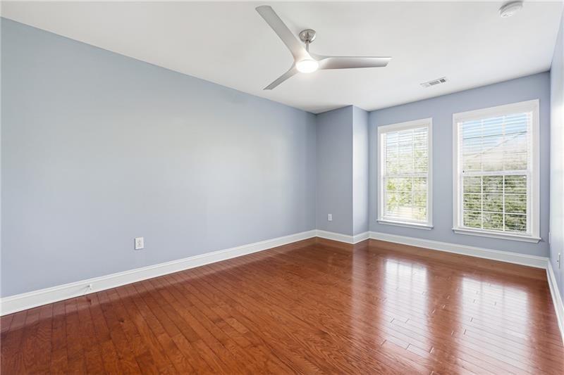 3655 East Paces Walk Atlanta, GA 30326 - Photo 10 of 31 a view of an empty room with wooden floor and a window