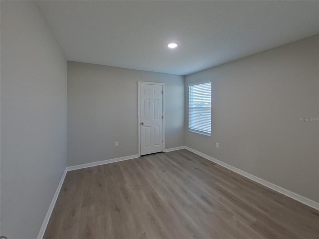 Undisclosed Address Apollo Beach, FL 33572 - Photo 13 of 20 an empty room with wooden floor and window