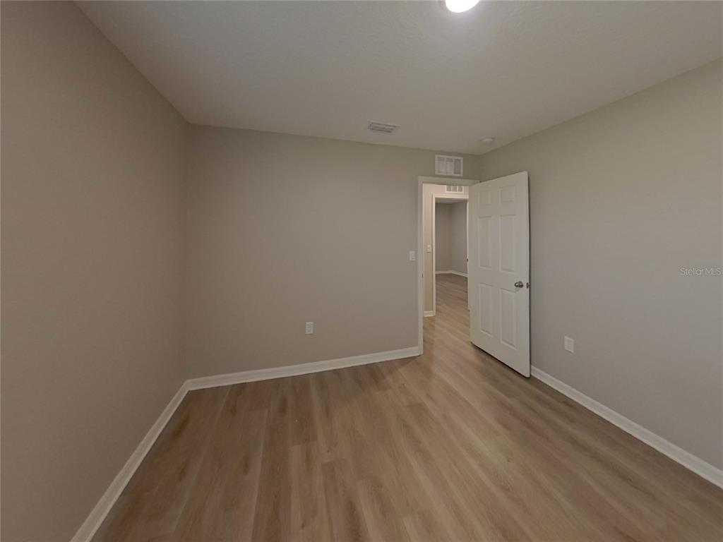 Undisclosed Address Apollo Beach, FL 33572 - Photo 14 of 20 a view of an empty room with wooden floor and a window