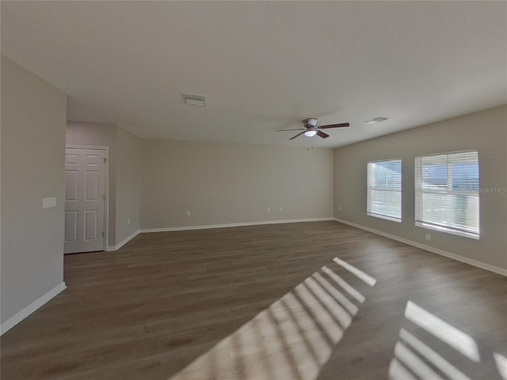 Undisclosed Address Apollo Beach, FL 33572 - Photo 3 of 20 a view of an empty room with wooden floor and a window