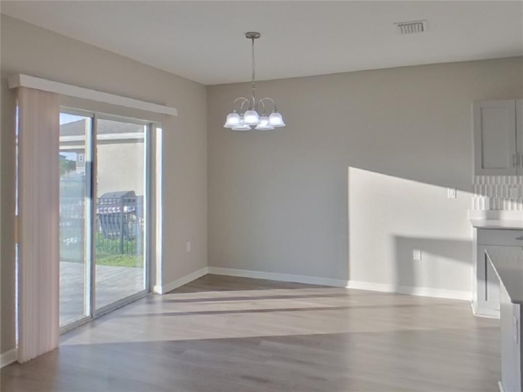 Undisclosed Address Apollo Beach, FL 33572 - Photo 4 of 20 a view of a livingroom with a chandelier fan and windows