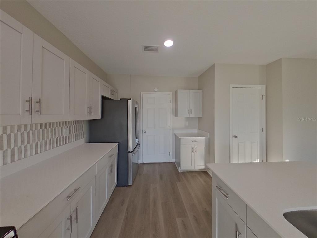 Undisclosed Address Apollo Beach, FL 33572 - Photo 5 of 20 a view of a kitchen with wooden floor and electronic appliances