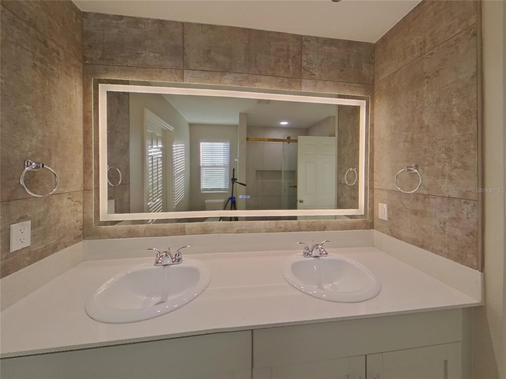 Undisclosed Address Apollo Beach, FL 33572 - Photo 9 of 20 a bathroom with a sink and a mirror