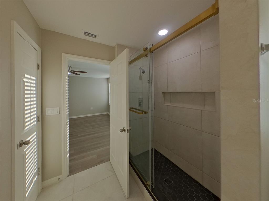 Undisclosed Address Apollo Beach, FL 33572 - Photo 10 of 20 a bathroom with a shower and a glass door