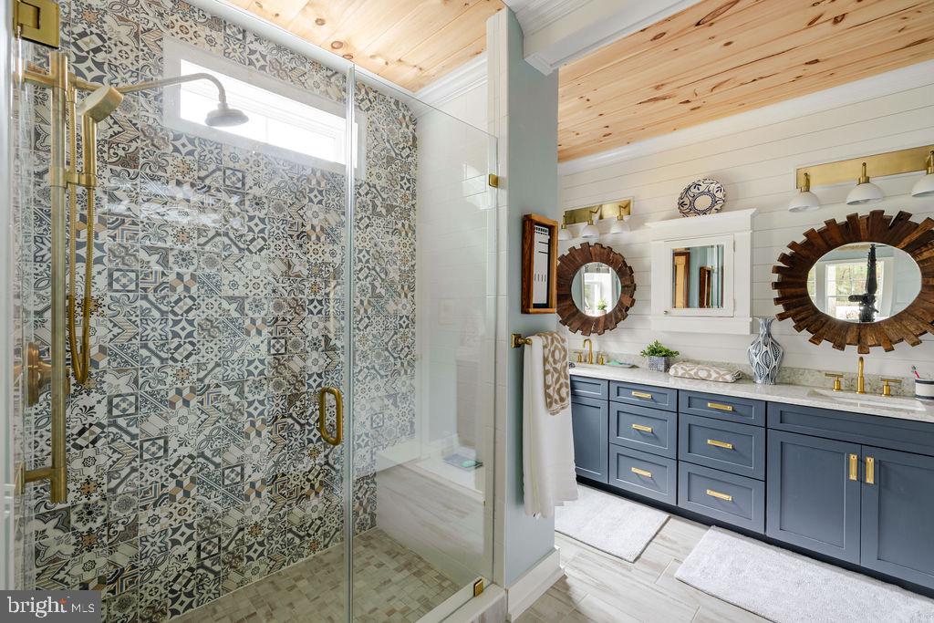 31673 Sloan Cove Road Lewes, DE 19958 - Photo 11 of 38 a bathroom with a granite countertop toilet a sink and a mirror