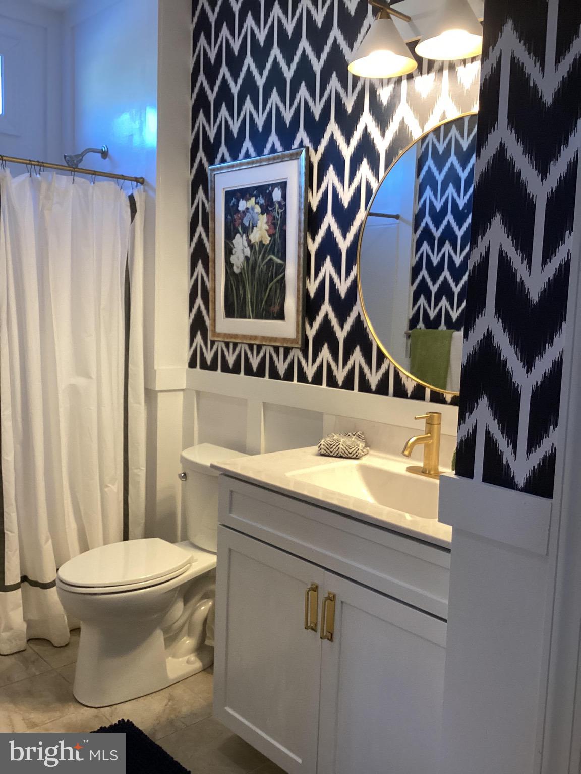 31673 Sloan Cove Road Lewes, DE 19958 - Photo 14 of 38 a bathroom with a sink and a toilet