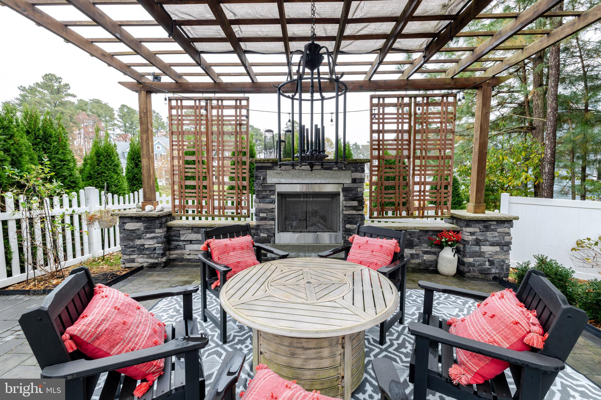 31673 Sloan Cove Road Lewes, DE 19958 - Photo 26 of 38 a outdoor living space with furniture and a fireplace