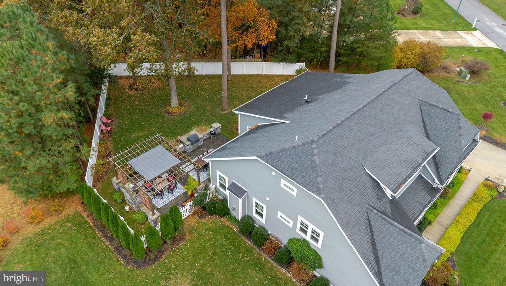 31673 Sloan Cove Road Lewes, DE 19958 - Photo 34 of 38 an aerial view of a house with swimming pool and large trees