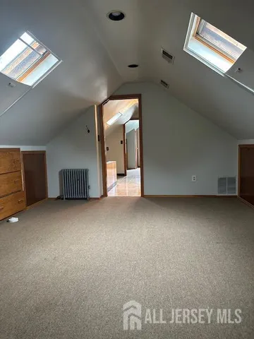 an empty room with a ceiling fan and window