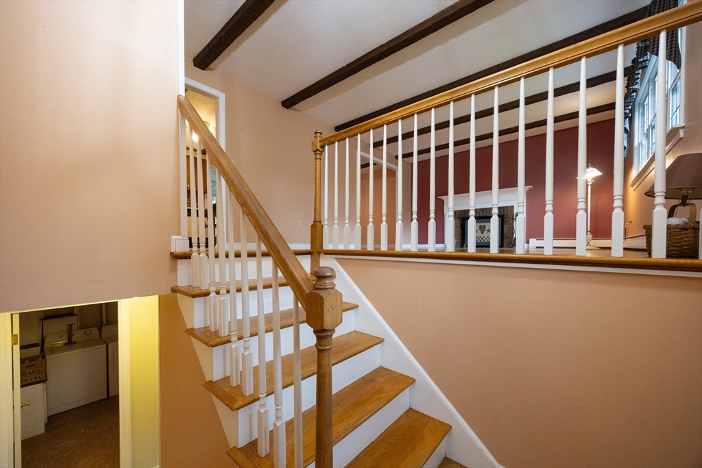 6 Clearview Drive Milford, MA 01757 - Photo 11 of 42 a view of staircase with lots of frames on wall and a window