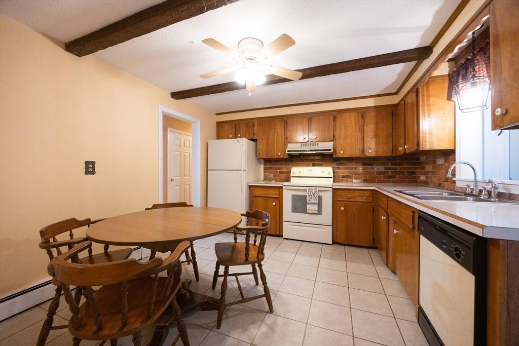 6 Clearview Drive Milford, MA 01757 - Photo 18 of 42 a kitchen with a table chairs stove and refrigerator