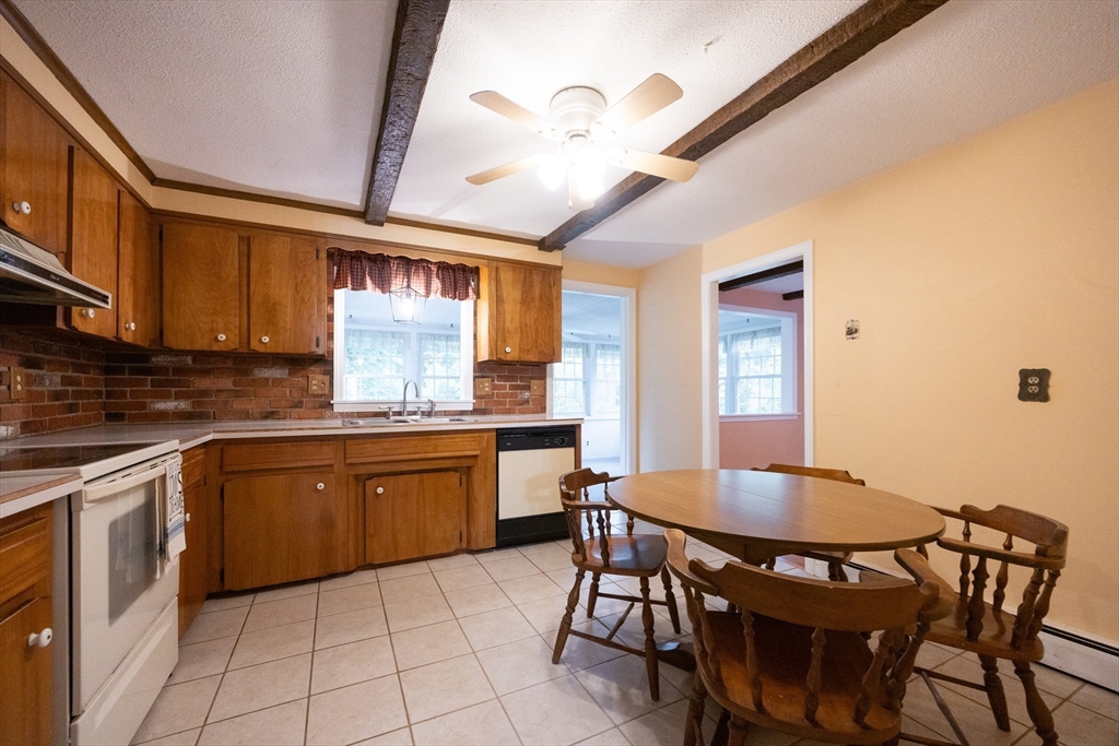 6 Clearview Drive Milford, MA 01757 - Photo 19 of 42 a kitchen with a dining table chairs cabinets and stainless steel appliances