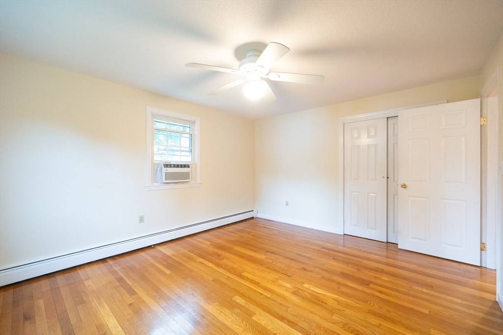 6 Clearview Drive Milford, MA 01757 - Photo 26 of 42 an empty room with wooden floor fan and windows