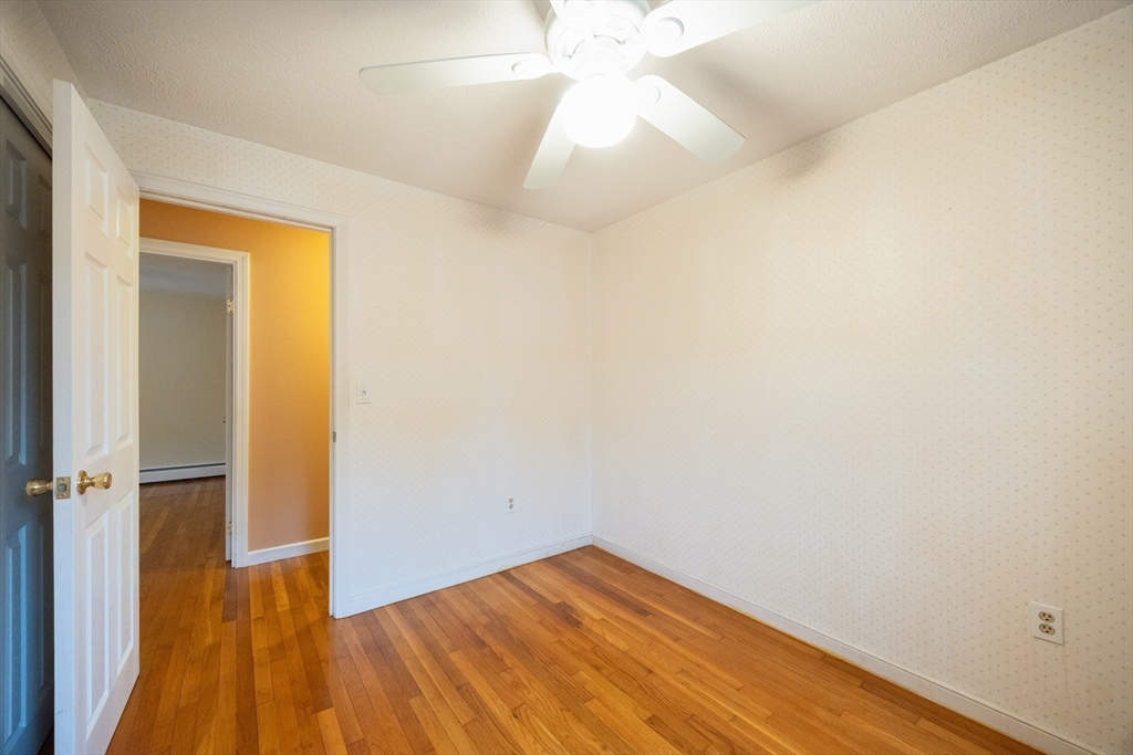 6 Clearview Drive Milford, MA 01757 - Photo 31 of 42 an empty room with wooden floor and a ceiling fan
