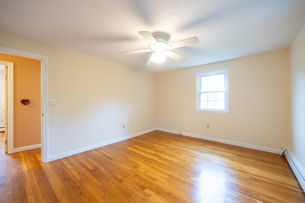 6 Clearview Drive Milford, MA 01757 - Photo 32 of 42 an empty room with wooden floor and windows