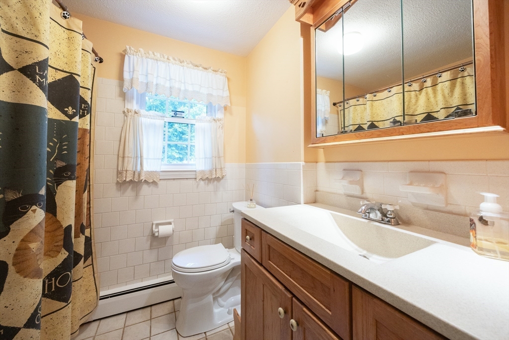 6 Clearview Drive Milford, MA 01757 - Photo 33 of 42 a bathroom with a sink a toilet and a mirror